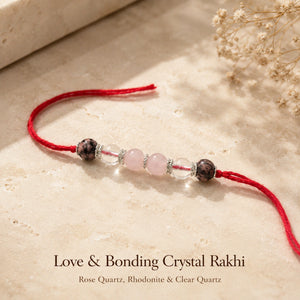 Love & Bonding Crystal Rakhi with Rose Quartz and Clear Quartz beside festive diya – Bellarosa Gems