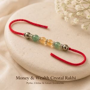 Money & Wealth Crystal Rakhi with Pyrite and Citrine beside festive diya – Bellarosa Gems