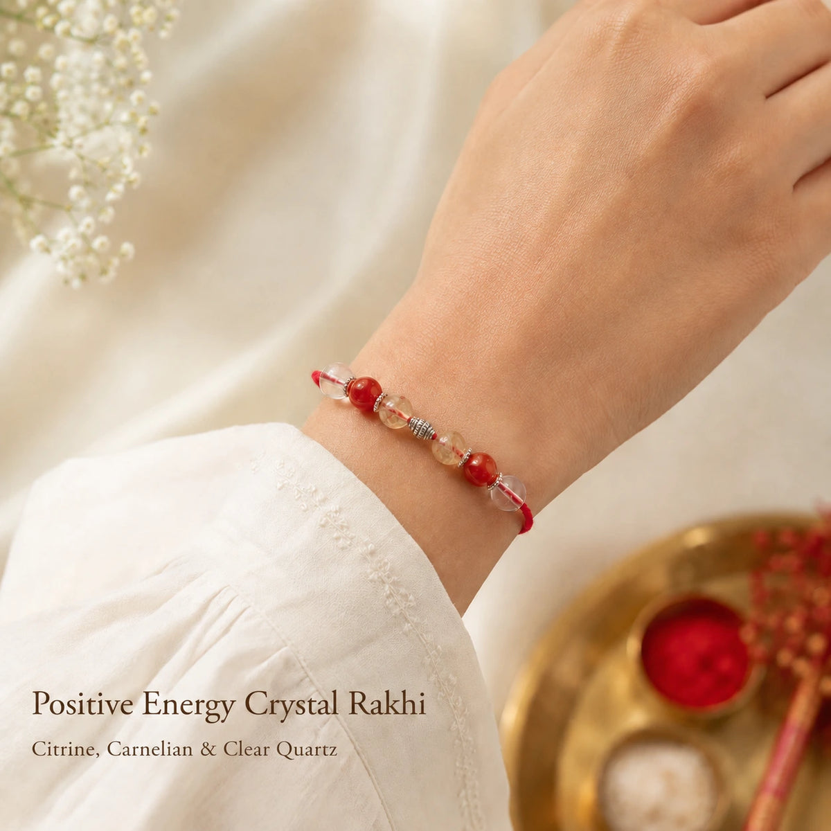 Positive Energy Crystal Rakhi with Citrine, Carnelian and Clear Quartz worn on wrist – Bellarosa Gems
