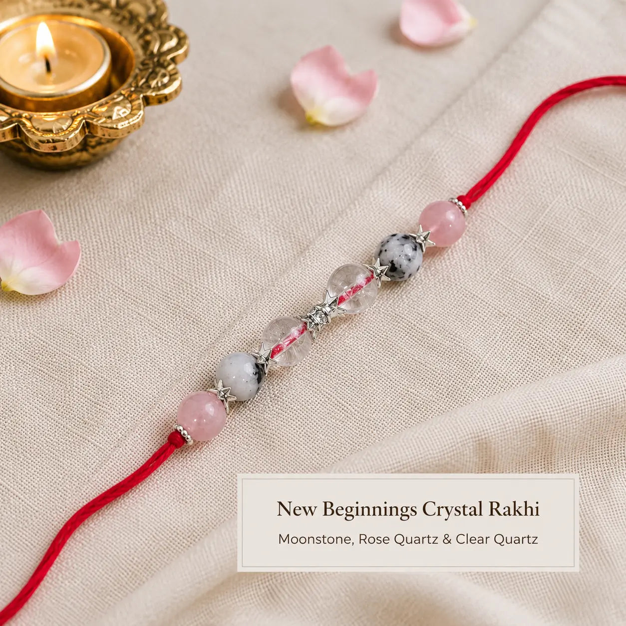 New Beginnings Crystal Rakhi with Moonstone and Clear Quartz beside festive diya – Bellarosa Gems