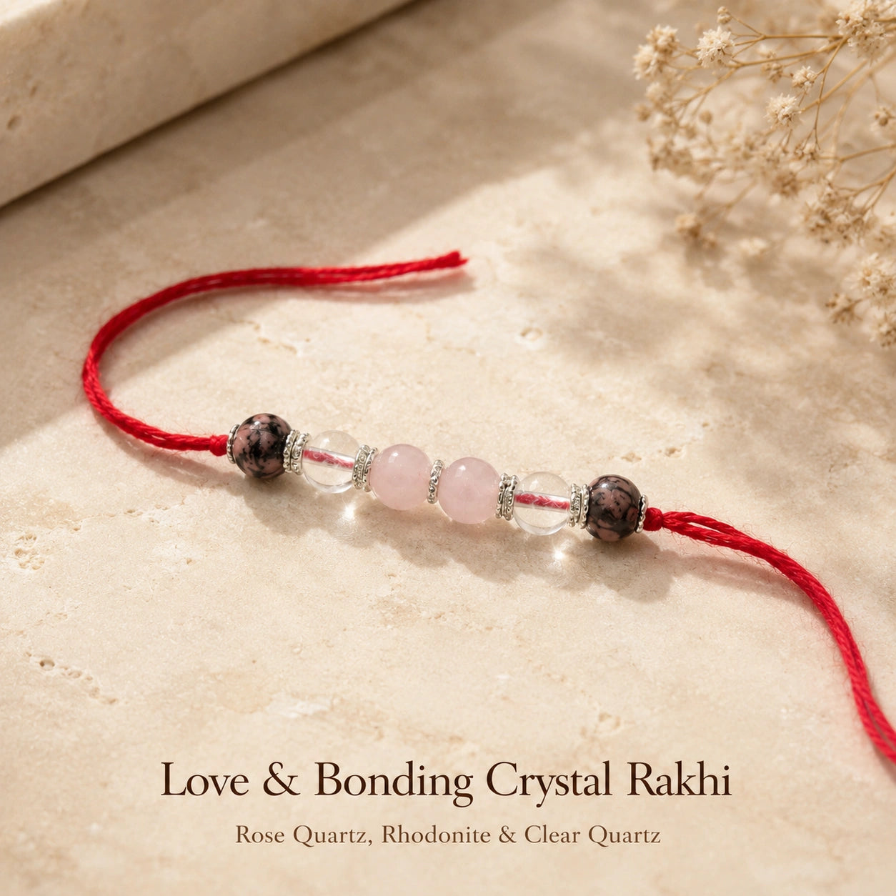 Love & Bonding Crystal Rakhi with Rose Quartz and Clear Quartz beside festive diya – Bellarosa Gems