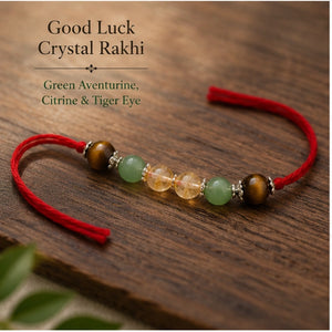 Good Luck Crystal Rakhi with Green Aventurine and Citrine beside festive diya – Bellarosa Gems