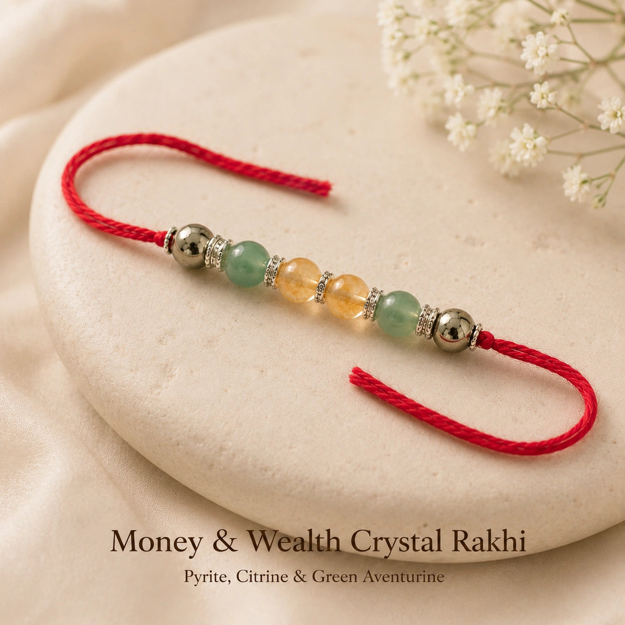 Money & Wealth Crystal Rakhi with Pyrite and Citrine beside festive diya – Bellarosa Gems