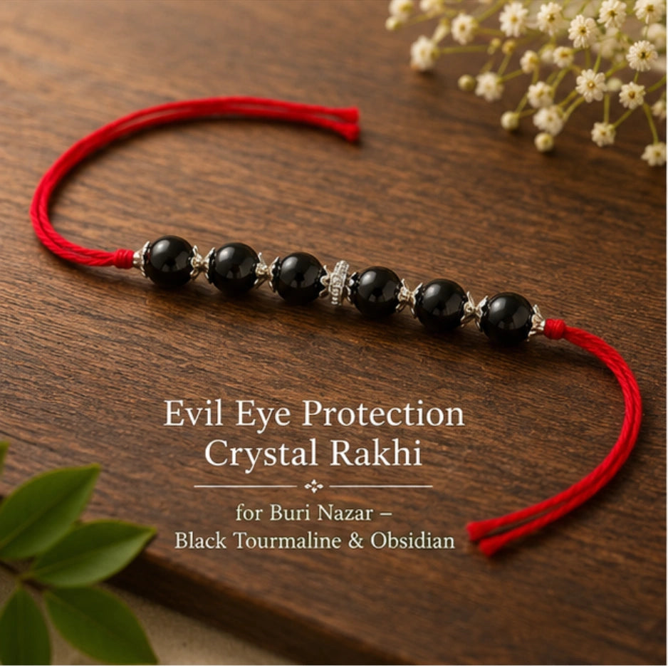 Evil Eye Crystal Rakhi with Black Tourmaline and Obsidian beside festive diya – Bellarosa Gems