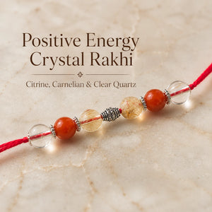 Positive Energy Crystal Rakhi with Citrine and Carnelian beside festive diya – Bellarosa Gems