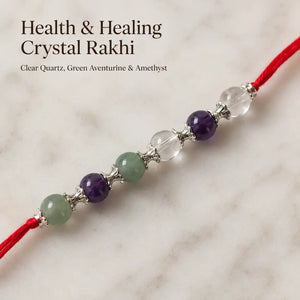 Health & Healing Crystal Rakhi with Clear Quartz and Amethyst beside festive diya – Bellarosa Gems